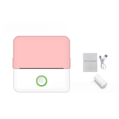 Small electronic device with pink top and white bottom, accompanied by a USB cable and manual on a white background.