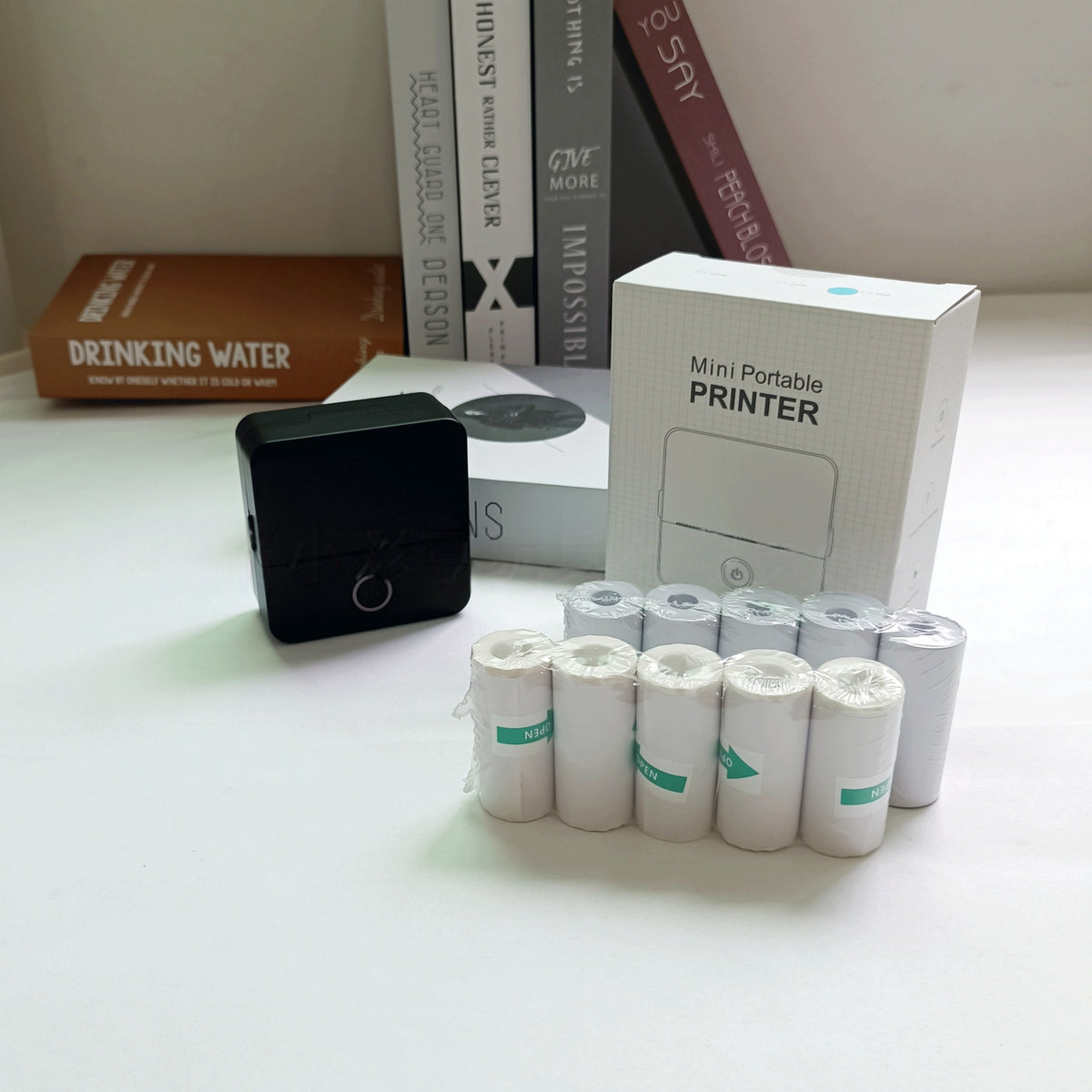 Mini portable printer with ink cartridges on a table