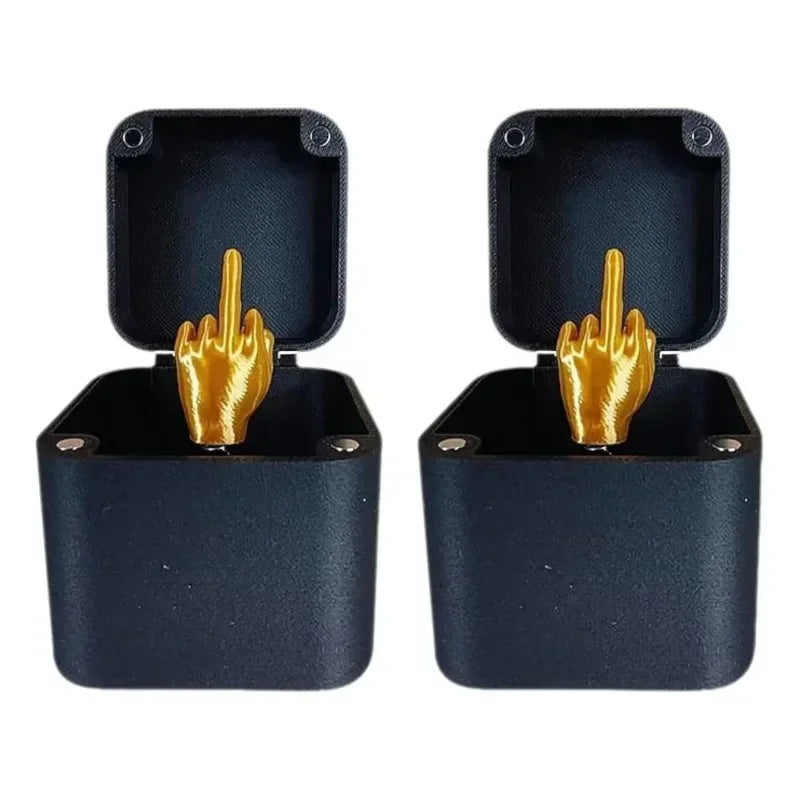 Two black cases with gold middle finger hand gestures on a white background