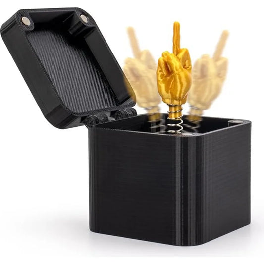 Black container with gold and beige hand-shaped objects inside on a white background