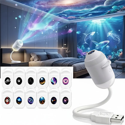 A white USB project lamp shown with a white cable and a row of 12 colorful projection icon options. The main lamp is displayed on a white background, while the upper half shows a bedroom scene with the lamp turned on and colorful light beams projecting onto the ceiling and wall, creating a galaxy and underwater scene.