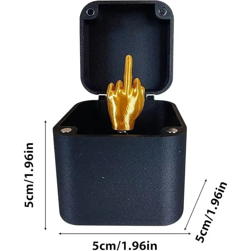 Black box with a gold middle finger figurine, showing dimensions on a white background