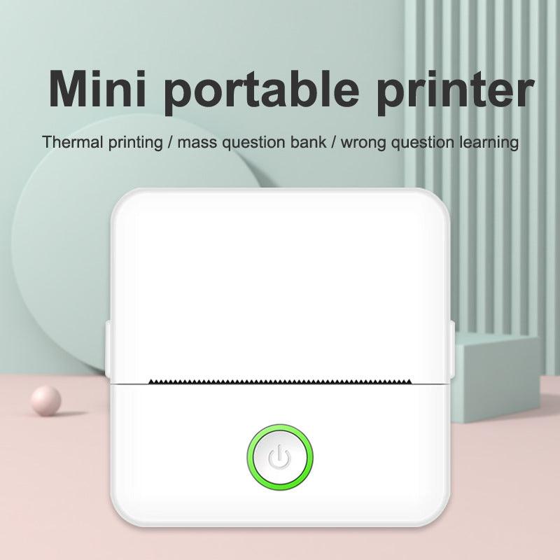 Mini portable printer with power button on a light background