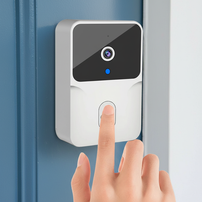A white smart video doorbell with a black camera panel and blue indicator light mounted on a blue door, with a hand pressing the front button.
