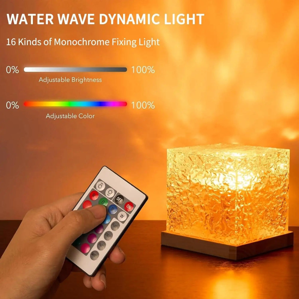 Hand holding a remote control with a water wave dynamic light on a wooden surface.