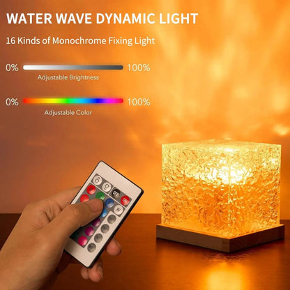 Hand holding a remote control with a water wave dynamic light on a wooden surface.